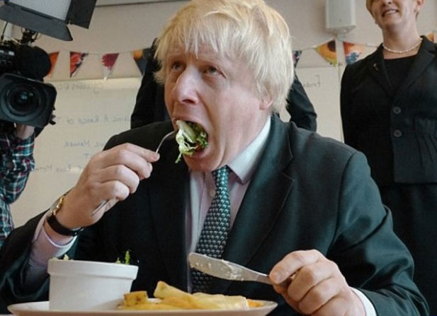 Boris shovelling food down his troff. He won't be Contracting a Branding Agency